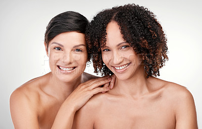 Buy stock photo Cropped portrait of two beautiful mature women posing against a grey background in studio