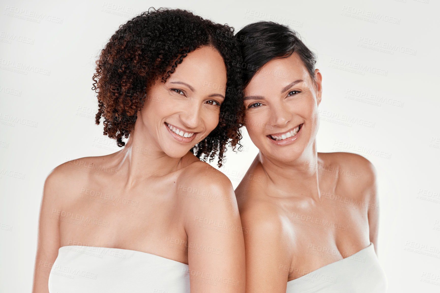 Buy stock photo Cropped portrait of two beautiful mature women posing against a grey background in studio