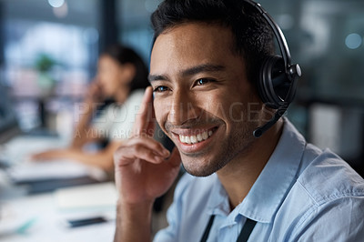 Buy stock photo Shot of a young man using a headset in a modern office