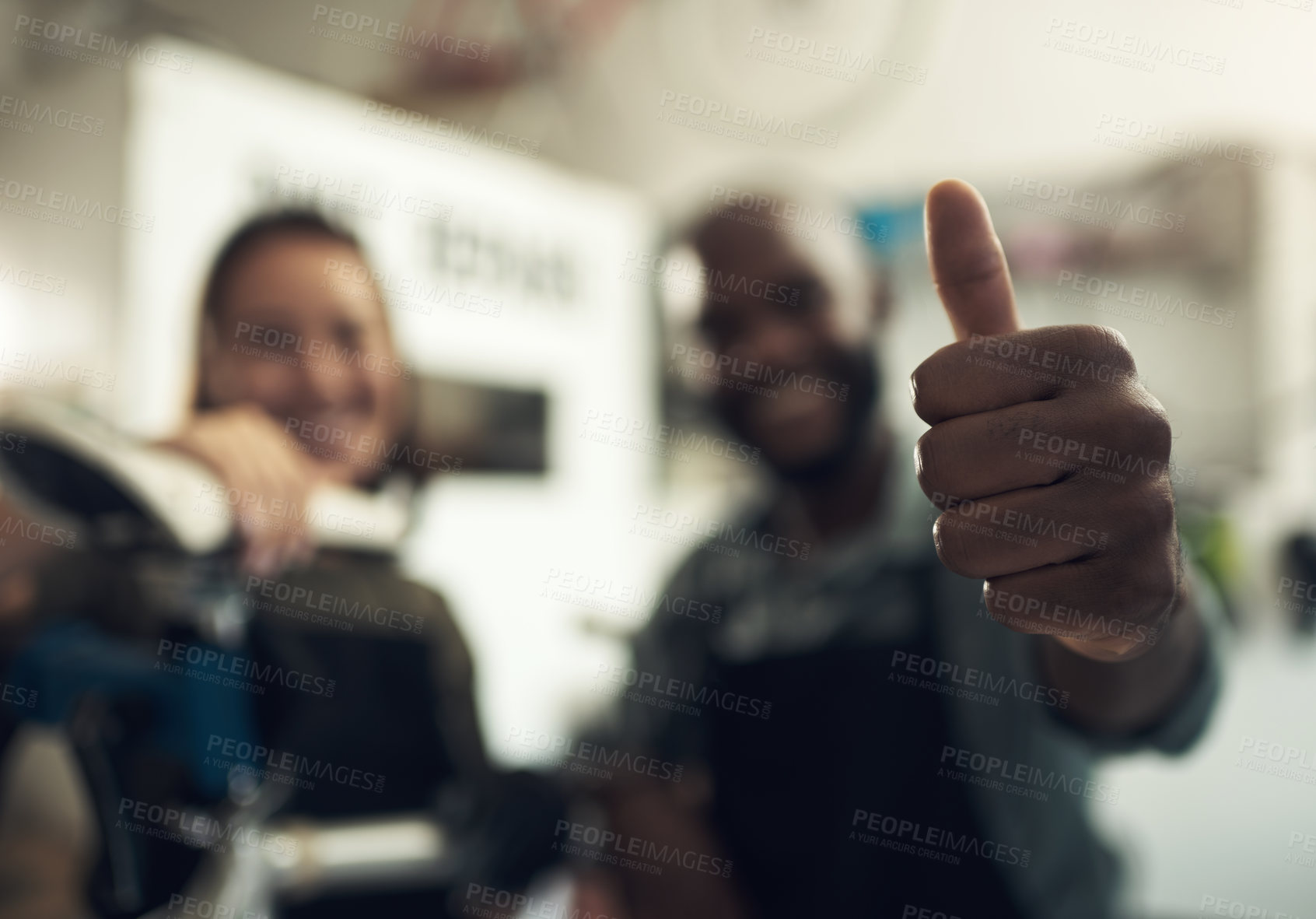 Buy stock photo Shot of two unrecognizable business owners standing together and making a thumbs up hand gesture in their bicycle shop