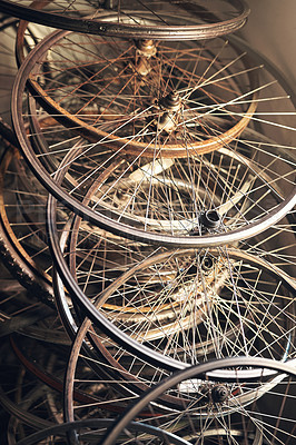 Buy stock photo Shot of bicycle wheel frames stacked on the floor