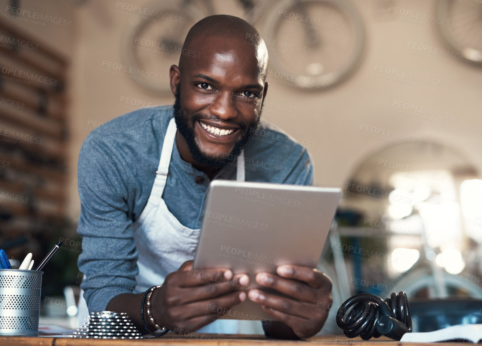 Buy stock photo Portrait of a young man using a digital tablet at work