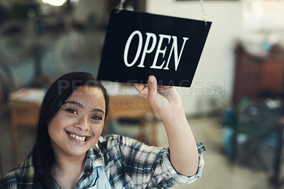 Buy stock photo Portrait of a young woman turning an open sign at work