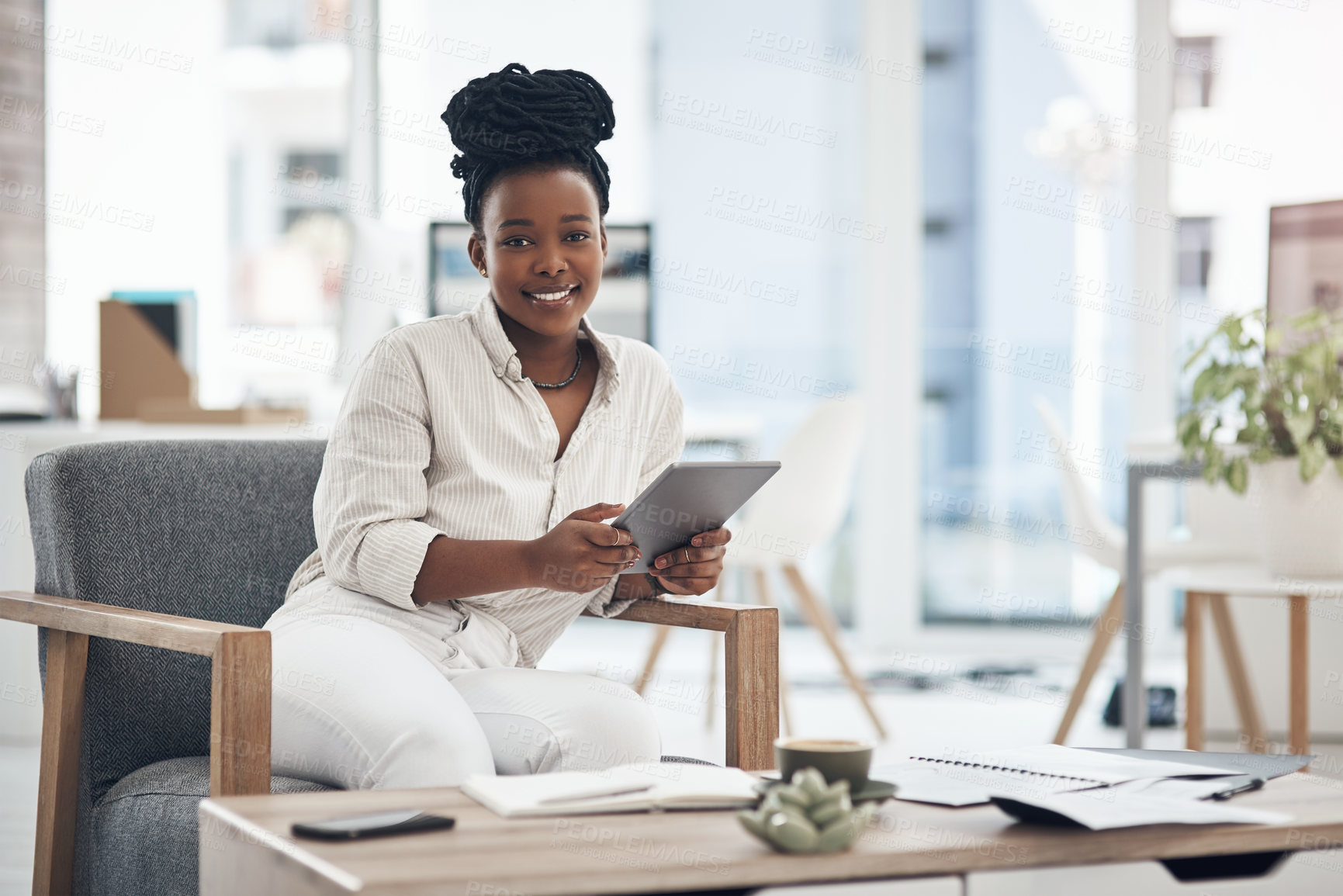 Buy stock photo Shot of a businesswoman using her digital tablet at work