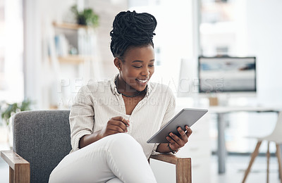 Buy stock photo Shot of a businesswoman using her digital tablet