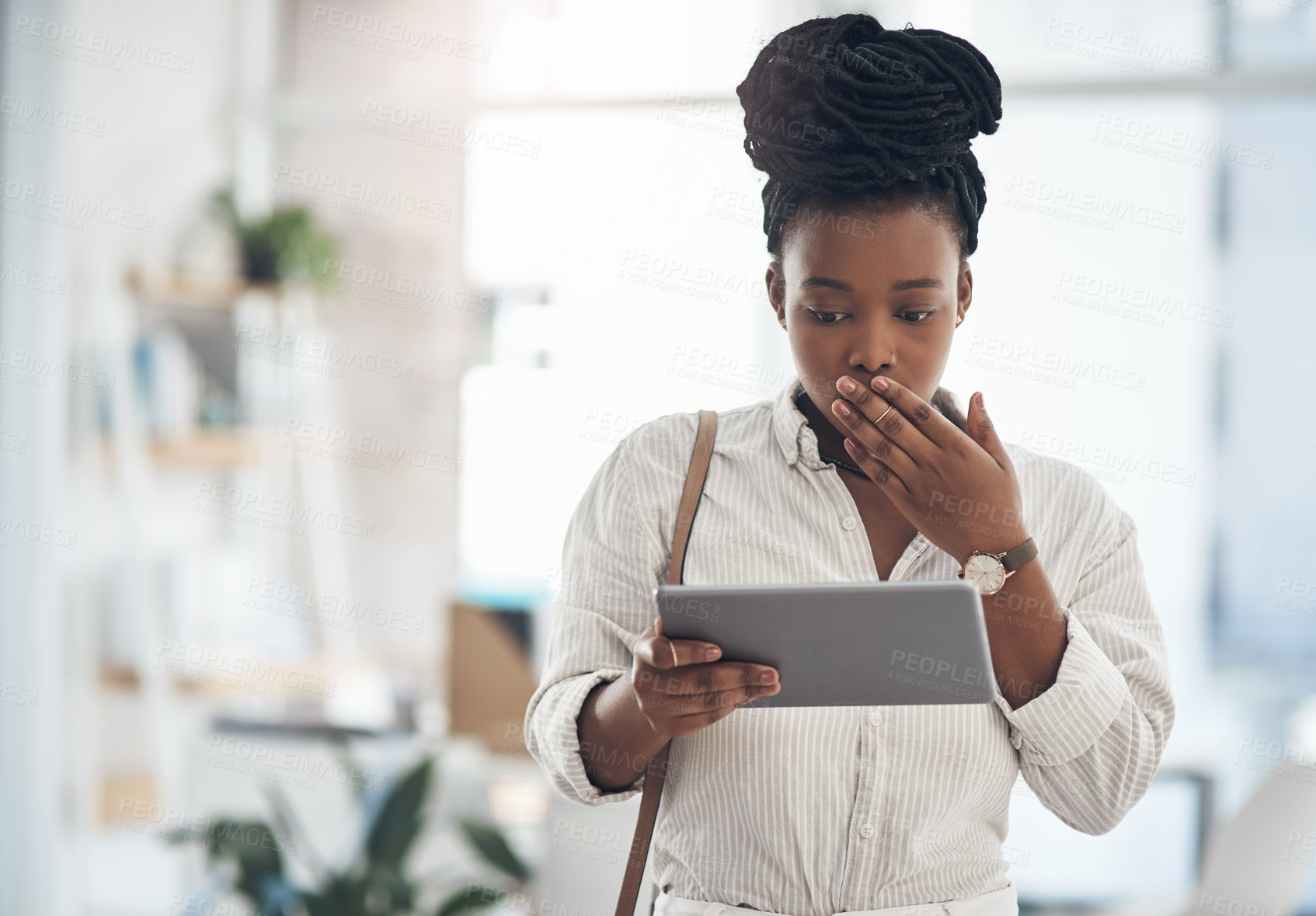 Buy stock photo Shot of a businesswoman using her digital tablet at work