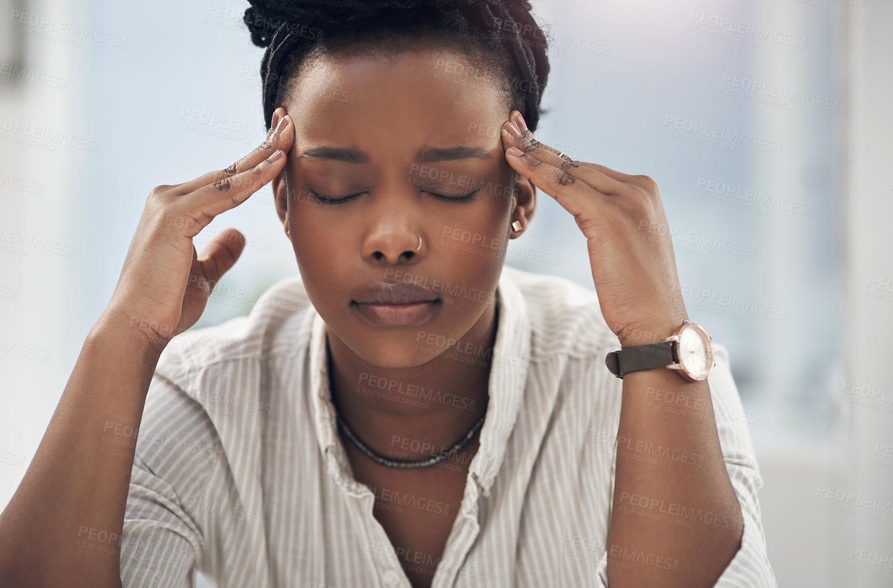 Buy stock photo Shot of a young businesswoman experiencing a headache while at work