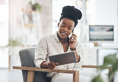 Buy stock photo Shot of a young businesswoman using her smartphone to make phone calls at the office while using her digital tablet