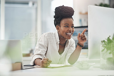 Buy stock photo Shot of a young businesswoman making notes in her notebook