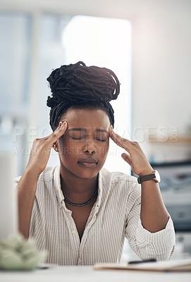 Buy stock photo Shot of a young businesswoman experiencing a headache while at work