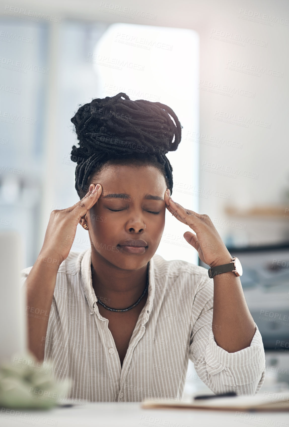 Buy stock photo Shot of a young businesswoman experiencing a headache while at work