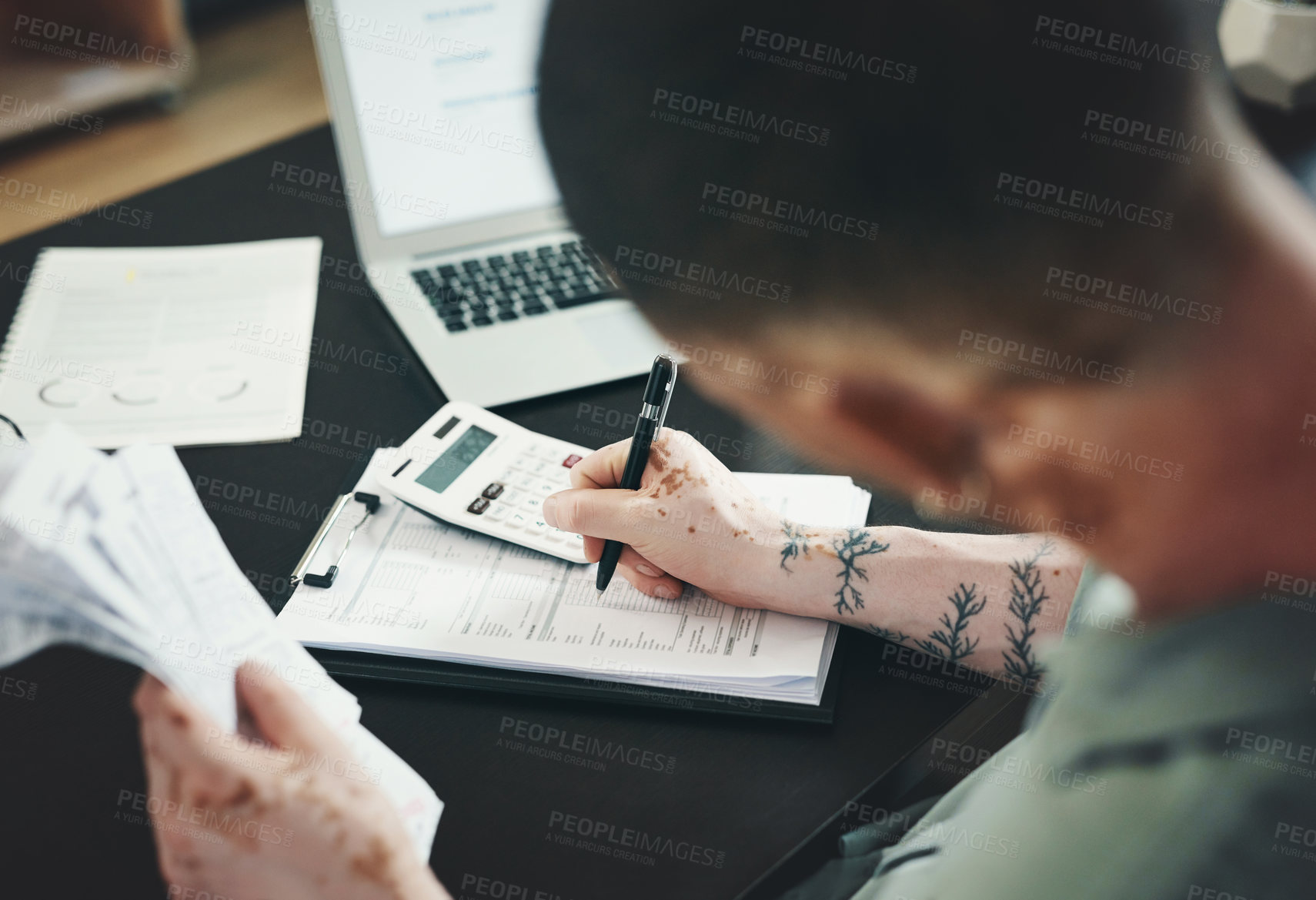 Buy stock photo Shot of an unrecognizable businessman doing paperwork in an office at work