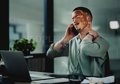 Buy stock photo Shot of a young businessman with neck pain while on a call in an office at work