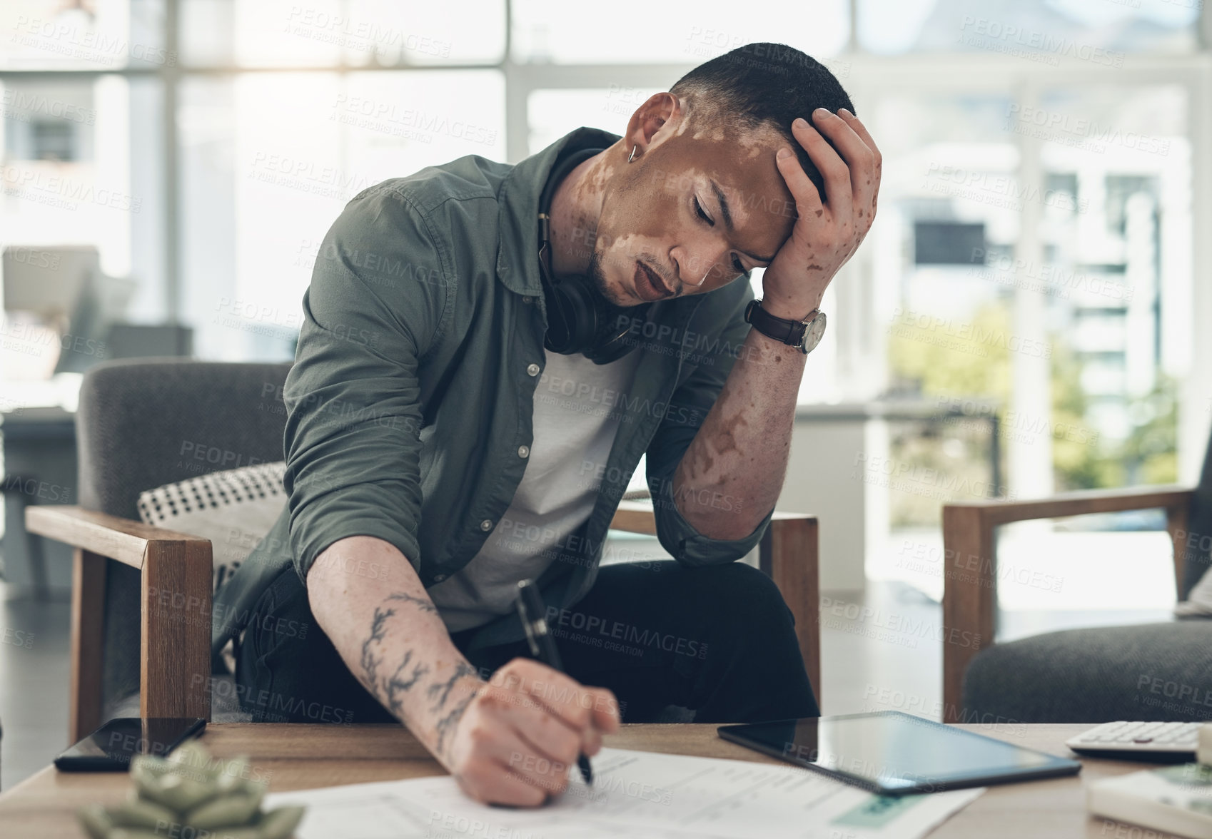 Buy stock photo Shot of a young business man working in a modern office