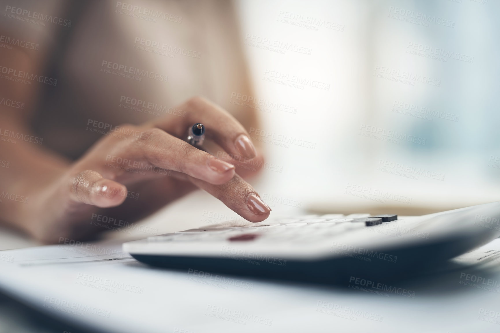 Buy stock photo Closeup shot of an unrecognisable businesswoman calculating finances in an office