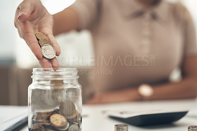 Buy stock photo Closeup shot of an unrecognisable businesswoman filling a glass jar with coins in an office