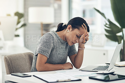 Buy stock photo Shot of a young businesswoman looking stressed out while working in an office