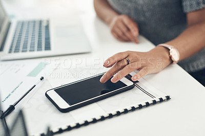 Buy stock photo Closeup shot of an unrecognisable businesswoman using a cellphone in an office