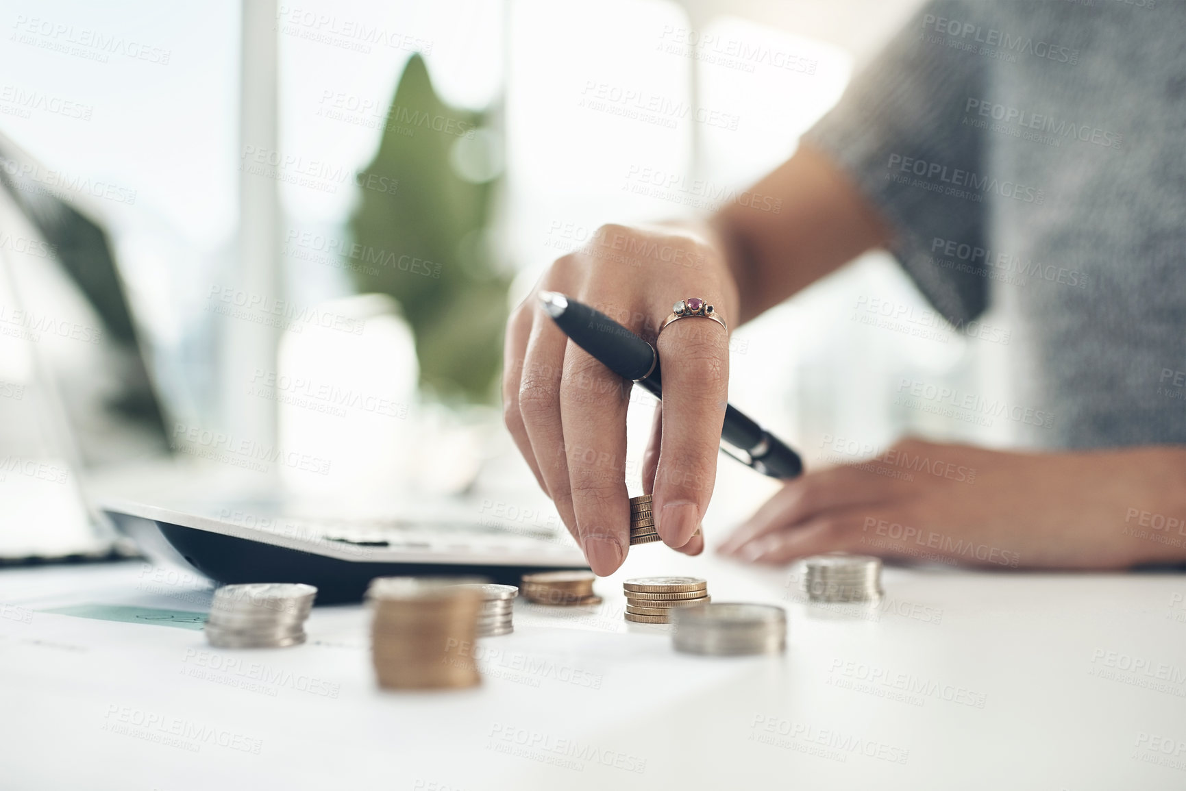 Buy stock photo Closeup shot of an unrecognisable businesswoman calculating finances in an office