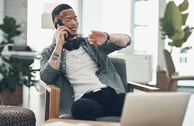 Buy stock photo Shot of a young business man on a phone call in a modern office