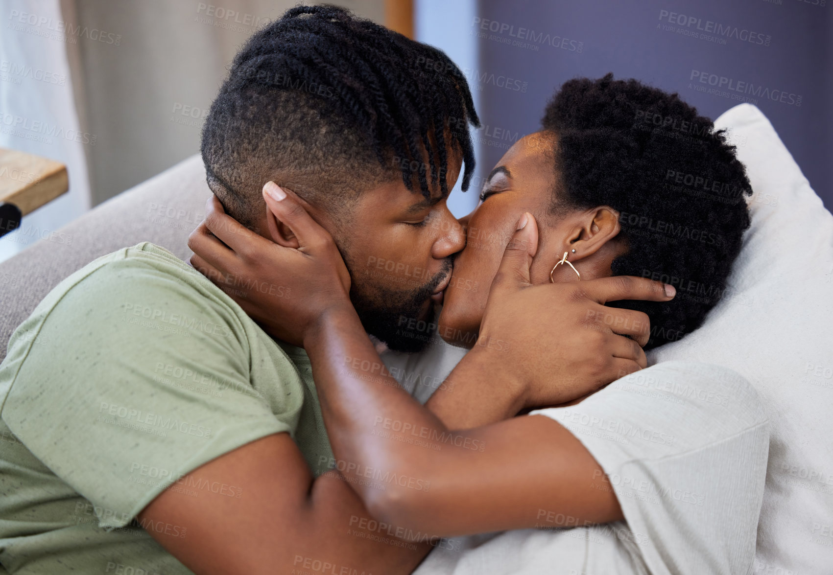 Buy stock photo Shot of a young couple kissing at home