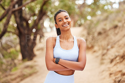 Buy stock photo Portrait, woman and exercise with confidence in forest for running workout, fitness watch and strong body. Indian athlete, pride and health in woods with wearable tech, nature run and sports training