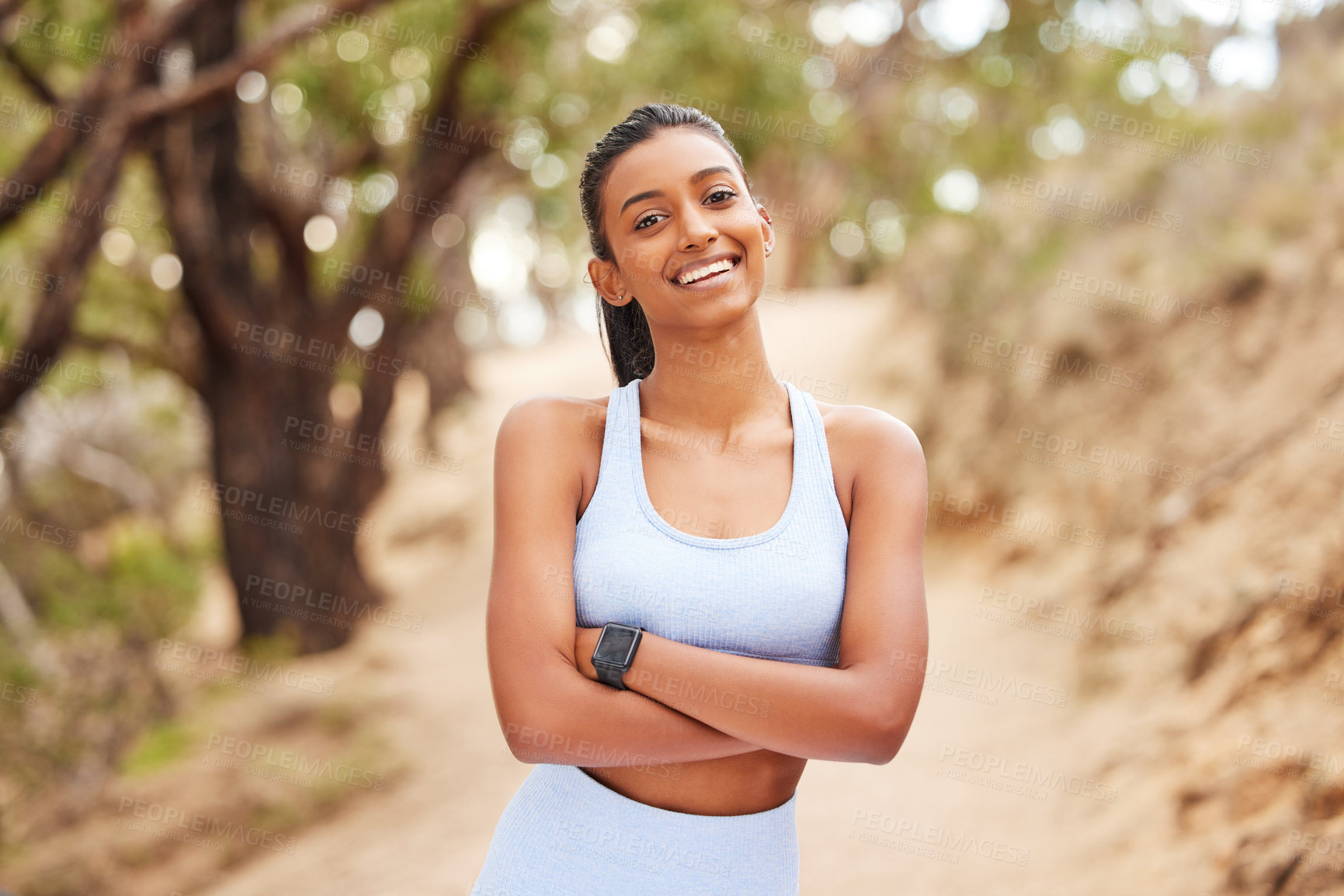 Buy stock photo Portrait, woman and exercise with confidence in forest for running workout, fitness watch and strong body. Indian athlete, pride and health in woods with wearable tech, nature run and sports training