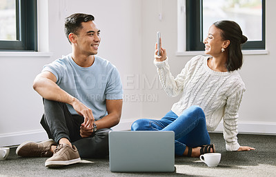 Buy stock photo Full length shot of an attractive young woman sitting and taking photographers of her boyfriend in their new home
