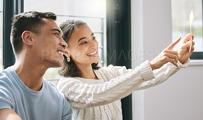 Buy stock photo Shot of a young couple sitting together and planning the interior design of their new home