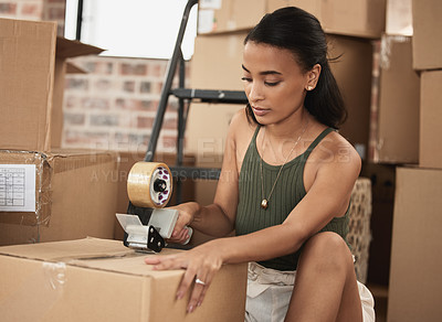 Buy stock photo Shot of a young woman packing up to move in a room at home