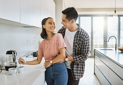 Buy stock photo Shot of a couple spending time together in the kitchen at home