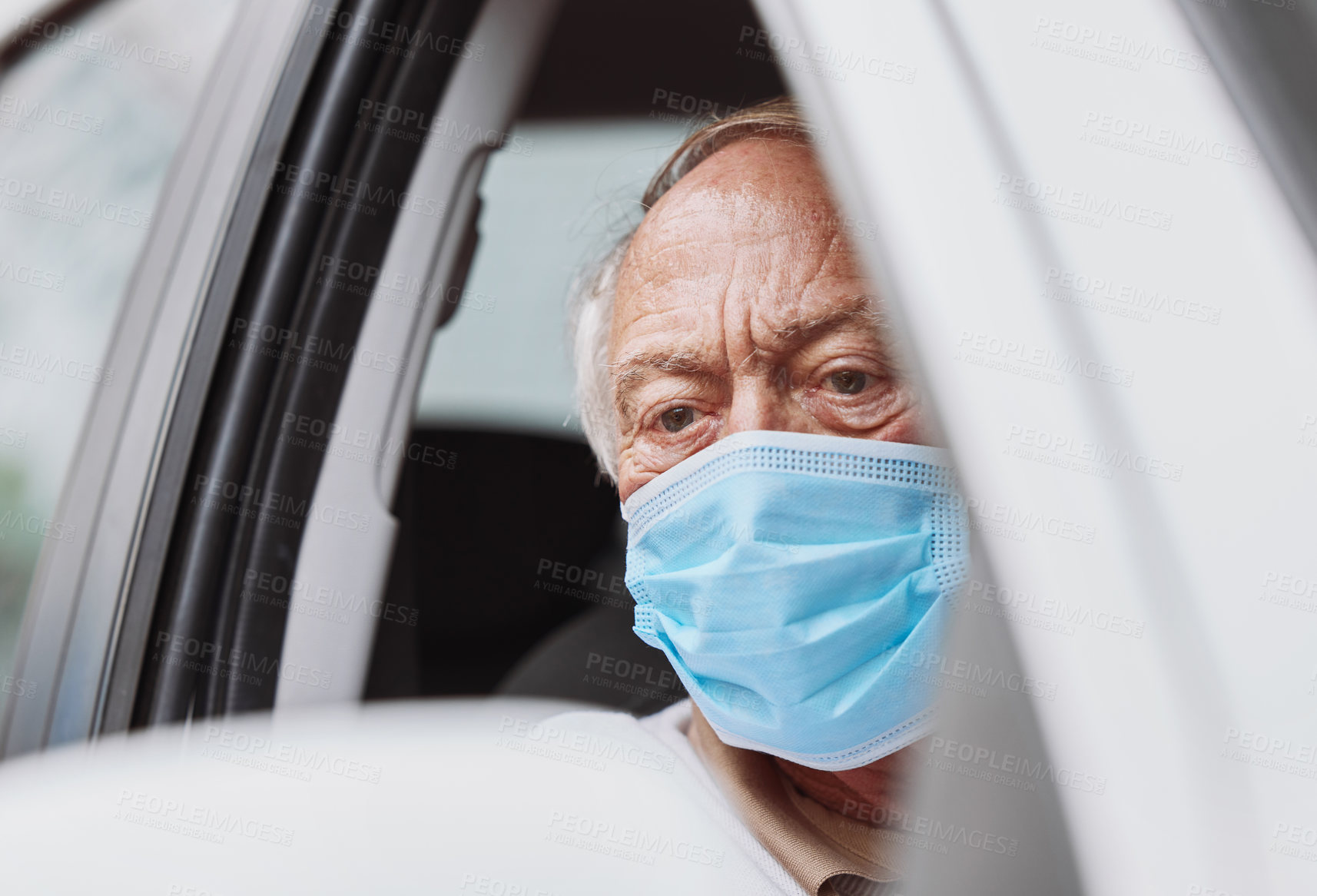 Buy stock photo Shot of a senior man waiting to get vaccinated at a drive through vaccination site