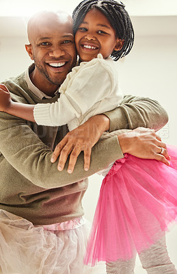 Buy stock photo Black man, daughter and hug with pride, home and love for compassion and happiness. African father, child and portrait with ballet hobby, tutu and dad with praise and welcome in family living room