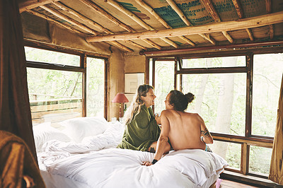 Buy stock photo Shot of a young couple relaxing on a bed while on holiday in a cabin