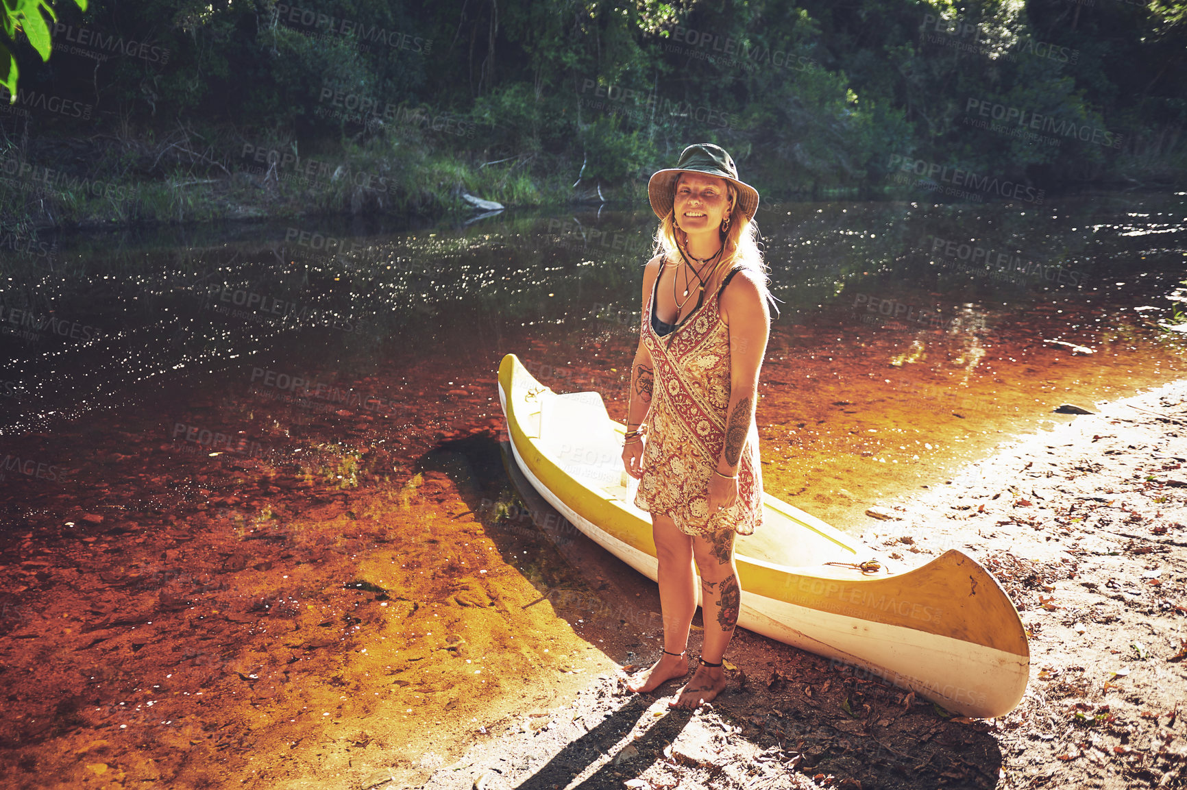 Buy stock photo Shot of a young woman out by the lake with a kayak