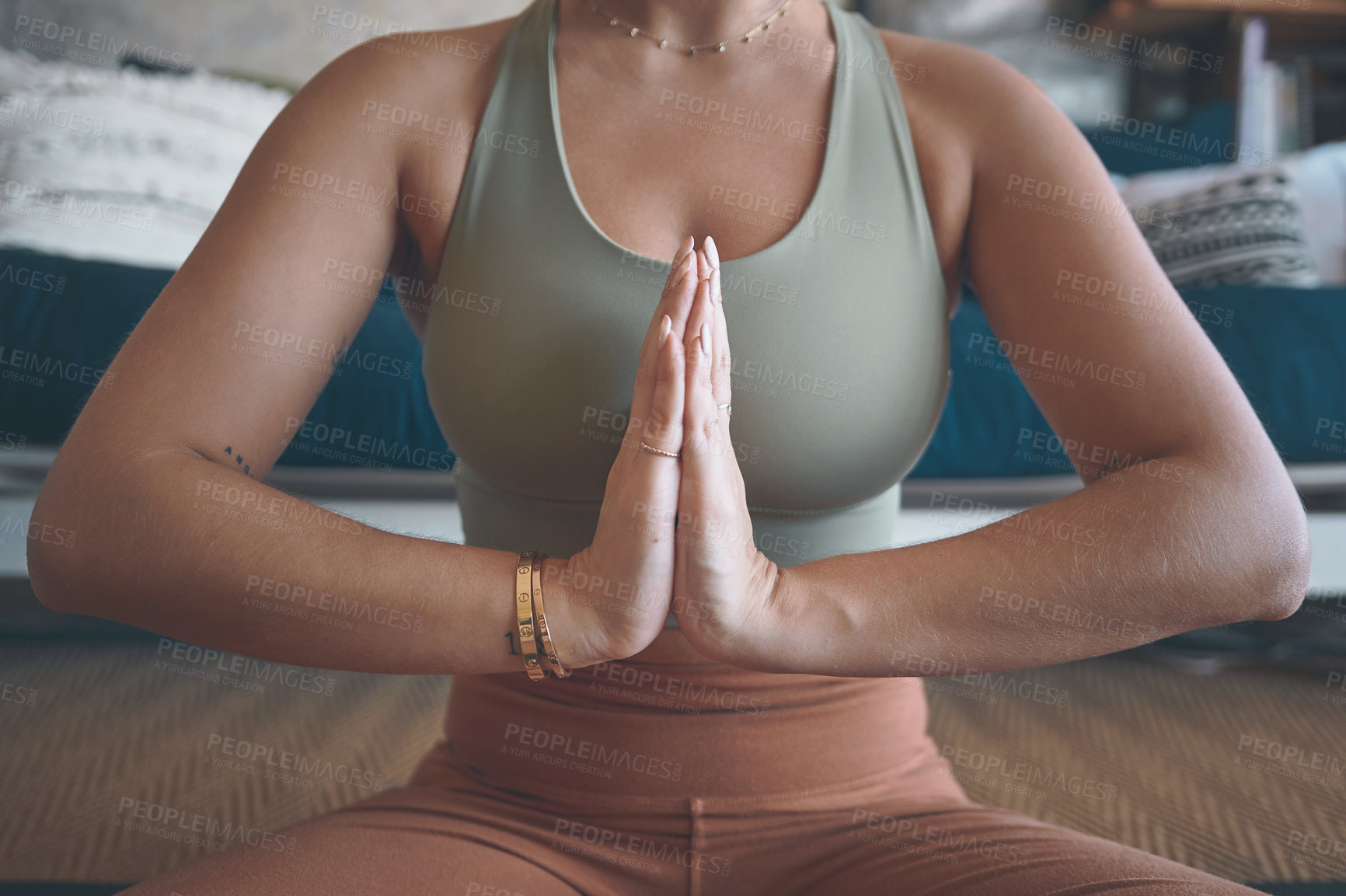 Buy stock photo Closeup shot of a woman meditating while practising yoga at home