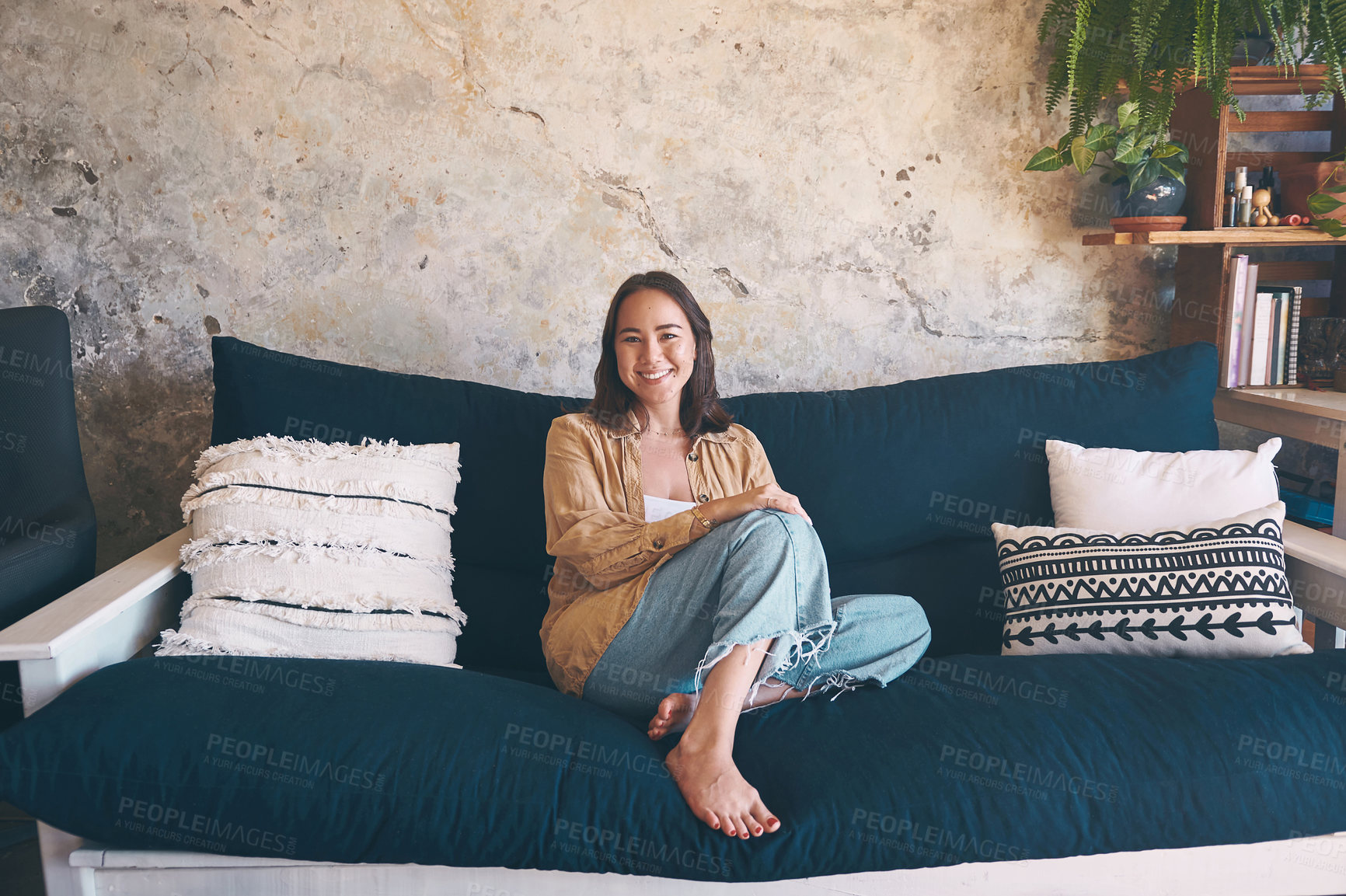 Buy stock photo Portrait of a young woman relaxing on the sofa at home