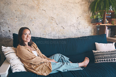 Buy stock photo Portrait of a young woman relaxing on the sofa at home