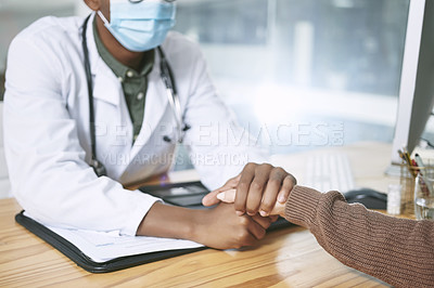 Buy stock photo Cropped shot of an unrecognizable doctor sitting with his patient and wearing a face mask while comforting her in the clinic