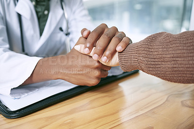 Buy stock photo Cropped shot of an unrecognizable doctor sitting with his patient and comforting her during a consultation in the clinic