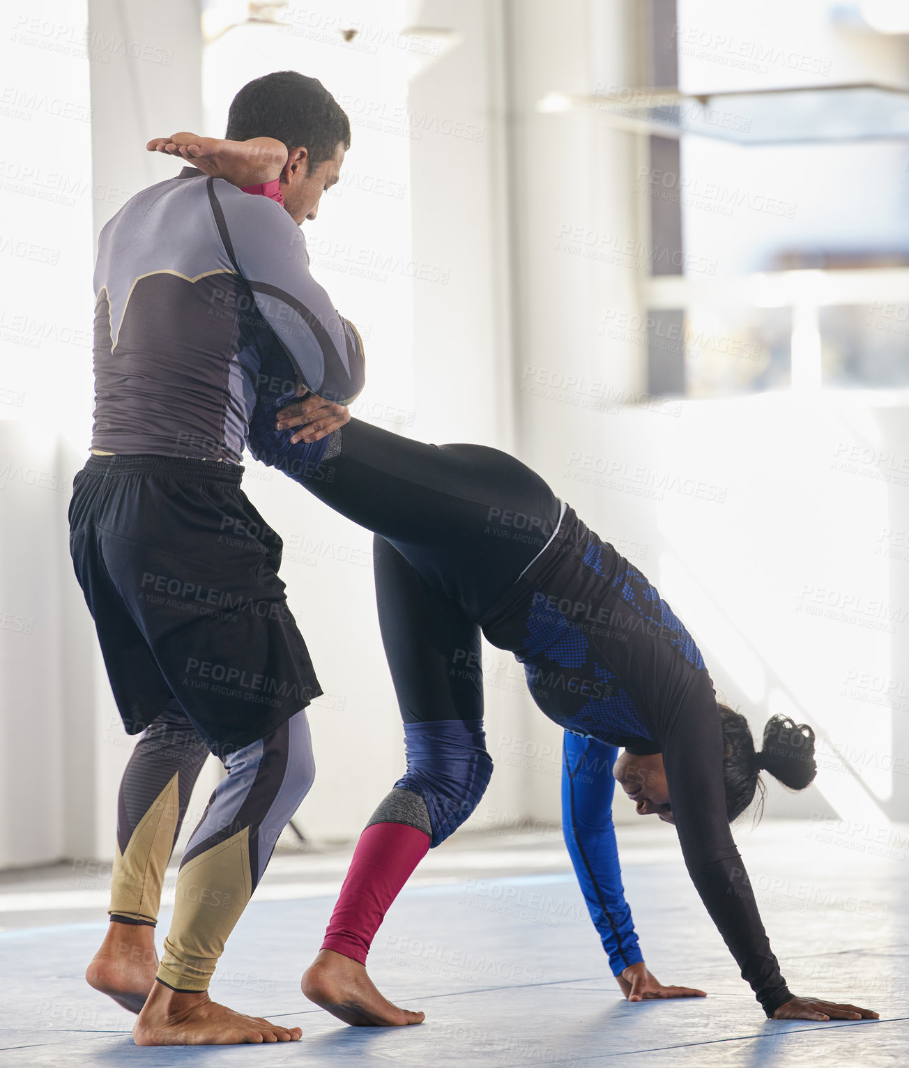 Buy stock photo Full length shot of a jiu jitsu sensei sparring with one of his students during a class