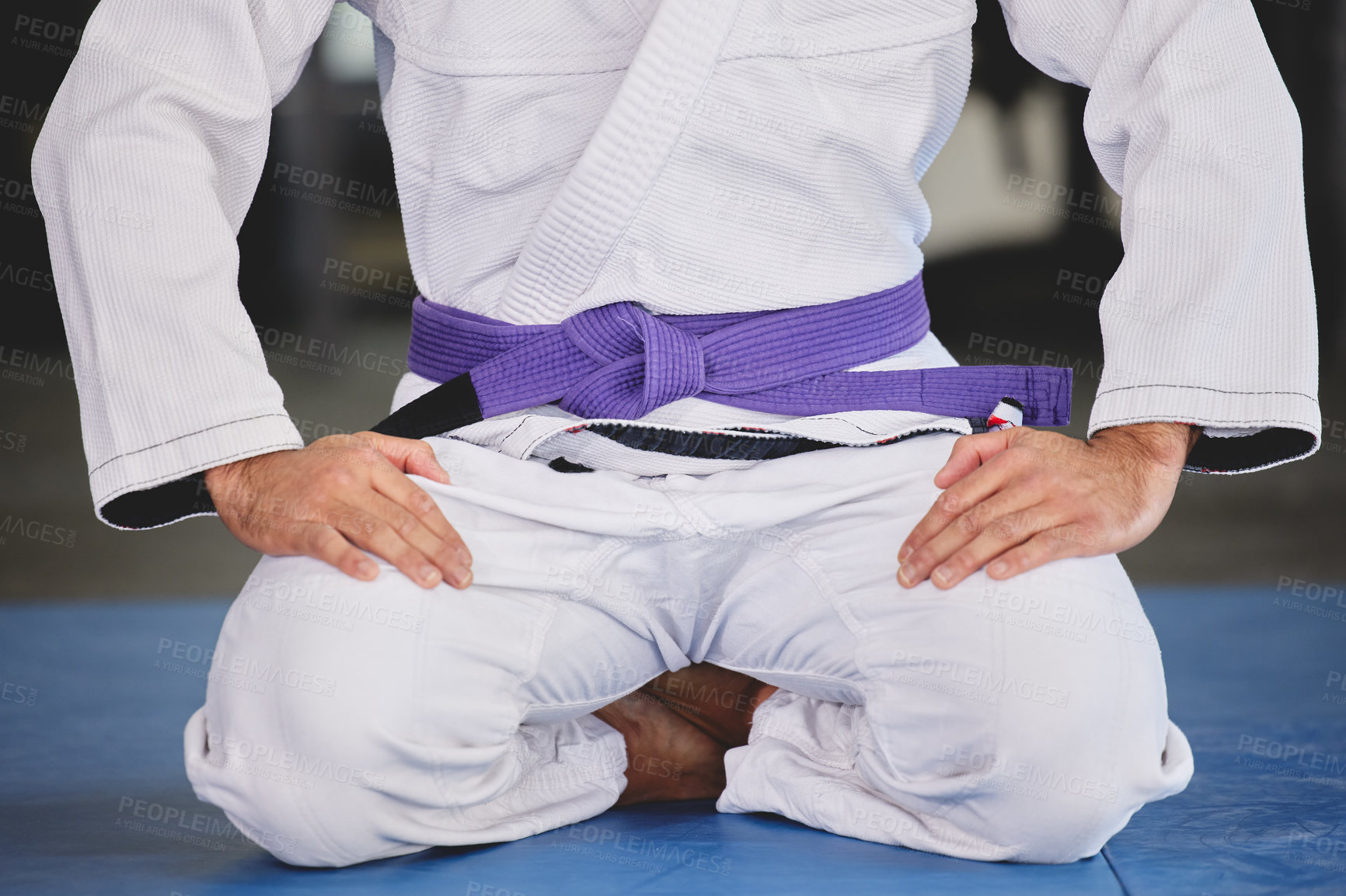 Buy stock photo Martial arts, fitness and person kneeling in gym for training, uniform and professional fighting sport. Health, wellness and Brazilian jiu jitsu athlete in dojo with gi, respect and sitting on mat