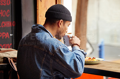 Buy stock photo Man, coffee shop and drinking at morning with breakfast in a restaurant with hot cappuccino. Cafe, brunch and table with hungry traveler with tea by the window of a bistro with food and latte
