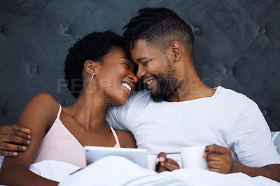 Buy stock photo Couple, bedroom and hug or love with tablet and coffee for morning bonding, weekend and honeymoon. Happy African man and woman cuddle together with digital technology for online streaming at home