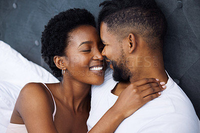 Buy stock photo Black couple and embrace in bed with smile for love, together and care on weekend morning. Comfort, dating and relaxing with passion for partner with relationship, waking up and rest in house.