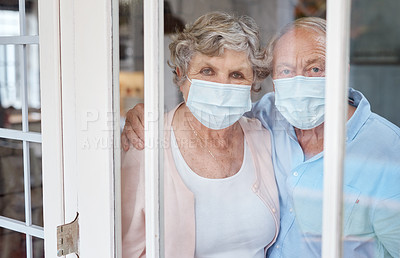 Buy stock photo Portrait of a masked elderly couple at home in isolation together