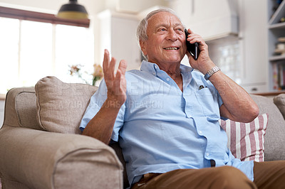 Buy stock photo Shot of an elderly man on a call using his cellphone on the sofa at home