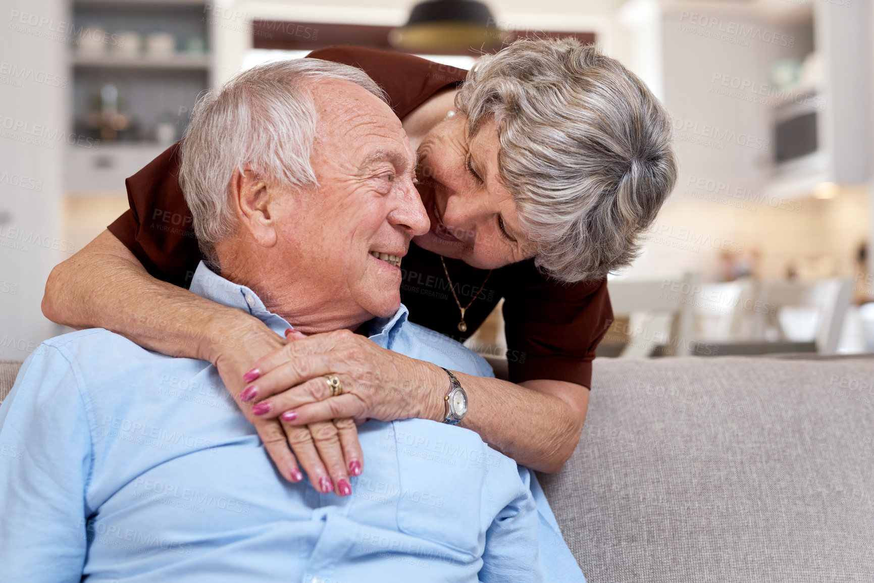 Buy stock photo Shot of an elderly couple being affectionate on the sofa at home