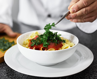 Buy stock photo Chef, hands and bowl with pasta for fine dining, serving or cooking recipe in kitchen at restaurant. Closeup of person, culinary artist or parsley on gourmet dish, Italian meal or food in hospitality