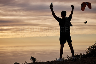 Buy stock photo Shot of a young man exercising in nature